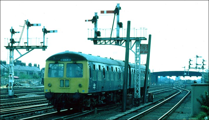 DMU with a train to to Ely just to the north of Cambrige station in BR days 