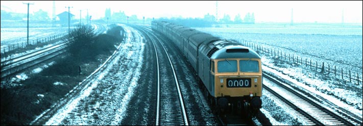 Class 47 on the ECML up fast line between Helpston and Woodcroft crossings gates on a very cold day