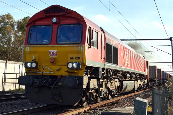 DB class 66 128 at Holme Load level crossing on the 25th October in 2021