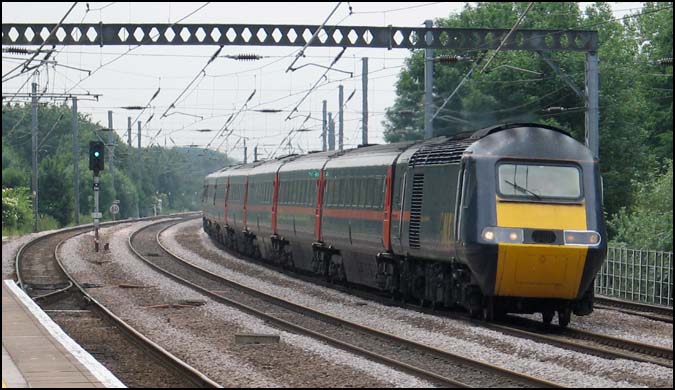 GNER HST with a down train on the down fast though Huntingdon station 2006