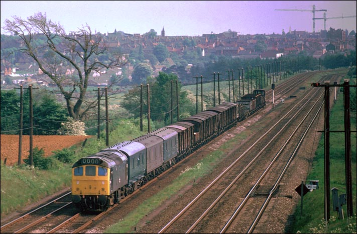 Class 25 on a mixed freight north of Kettering station in BR days. 