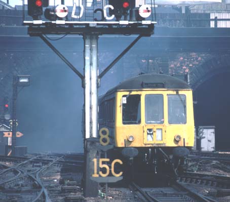 A DMU comes out from a fume filled Gas works tunnel