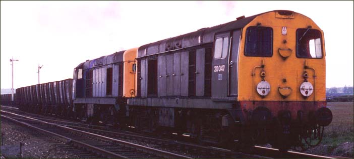 Two class 20s with 20047 and 20180 come out from the slow line at Langham Junction. 