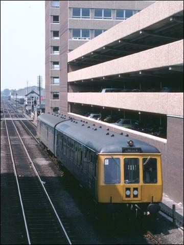 DMU is  coming into Lincoln Central station past the car park 