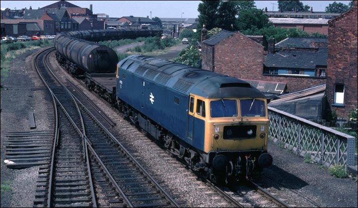 Class 47 701 comes from St Marks Station with a train of tank wagons. 