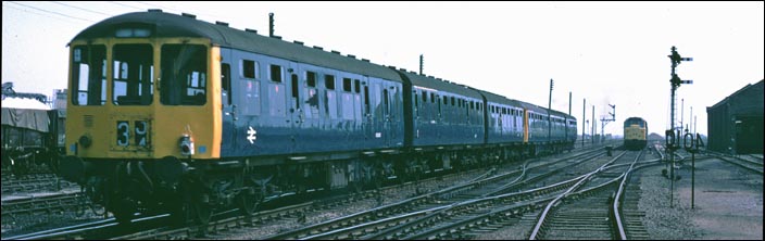 Two three car DMUs heading for Ely 