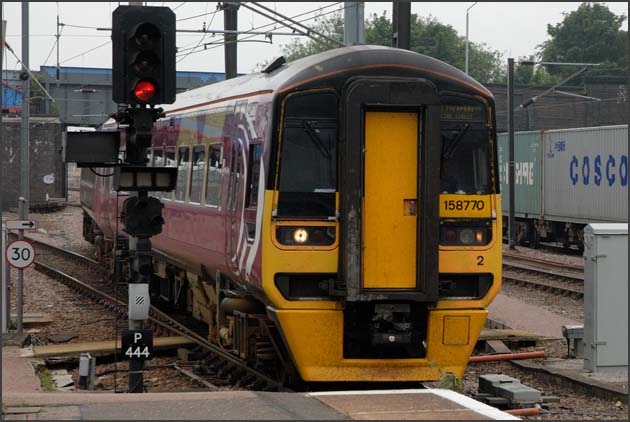  158770 comes off the Peterborough to March line into platform 5 at Peterborough station