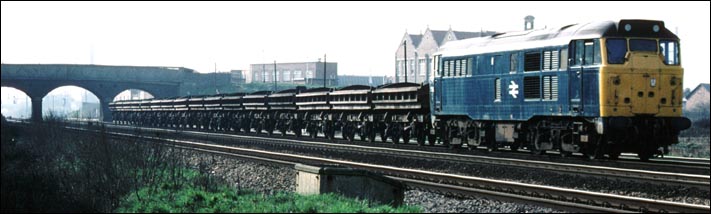 A class 31 with a train of ballast wagons at Fletton