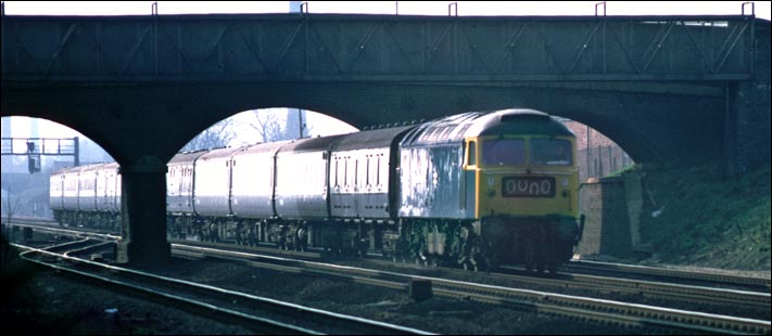 A class 47 on a down train which has just come under the Fletton High Street road bridge