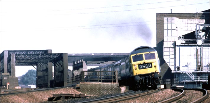 A class 47 is just crossing the Peterborough to March railway line. The rest of the train is on the river Nene bridges