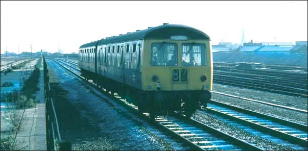 DMU in BR days going past the old platforms of the East station at Peterborough