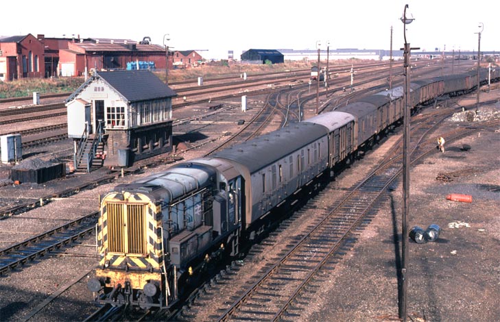 Class 08 272 with a long mixed parcels train 