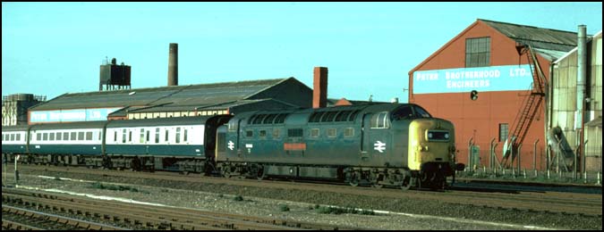 A class 55 Deltic on the up fast on the ECML at Walton next to Peter Brotherhood Factory  