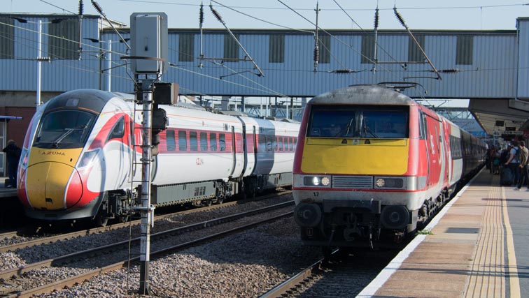 LNER Azuma in platform 3 with class 91117 coming into platform 4