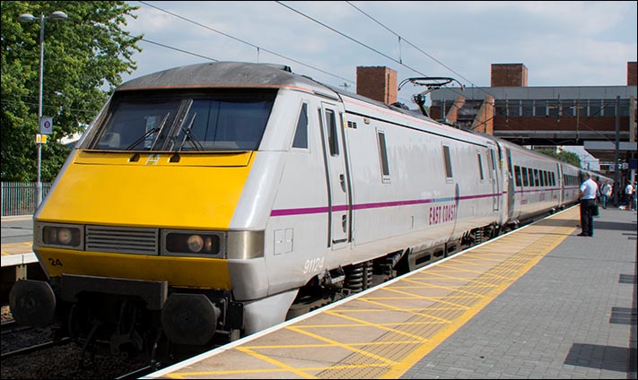 East Coast class 91124 on a Down train in Stevenage station on the 29th of July 2014
