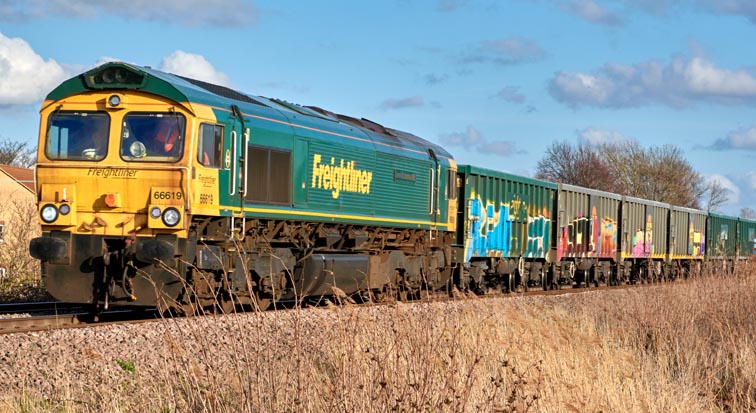 Freightliner class 66619 at  Black Bush level crossing Whitlesea on the 9th March in 2022 