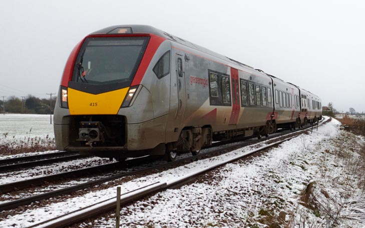 Greater Anglia Peterborough train at the Ramsey Road crossing