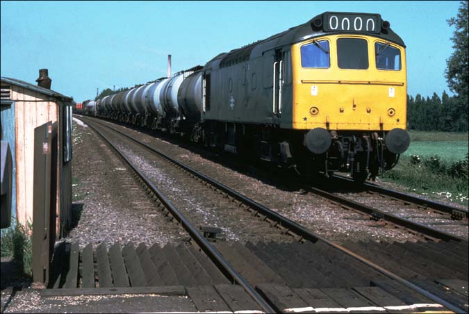  Whittlesea a class 25 heads for March with a long frieght of tank wagons.