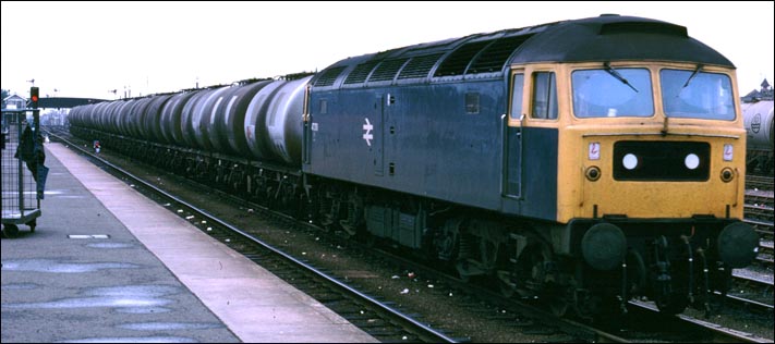 class 47 on a tanker train comes past Cambridge station