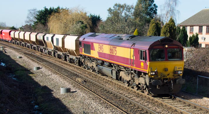 DB Class 66175 with  a train of hopper wagons at March West Junction 