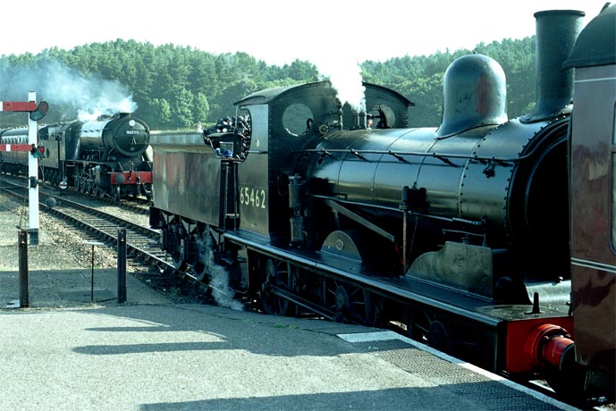 J15 65462 waits at Weyborne station as 2-10-0 90775 comes into the station 