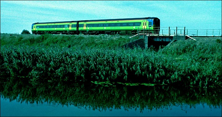  Central Trains class 158 at Turves about to cross over the old course of the River Nene in 2003