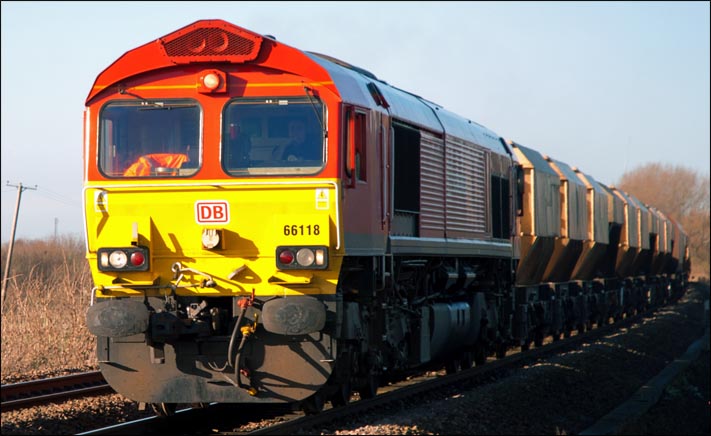 DB class 66118 at Black bush level crossing on a train of hooper wagons on Monday 13th of January heading towards March